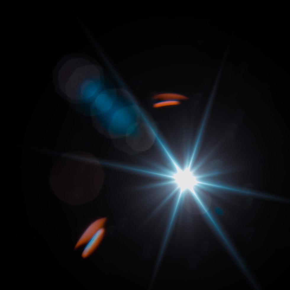 Lens flare and light leak haze texture on a black background. photo