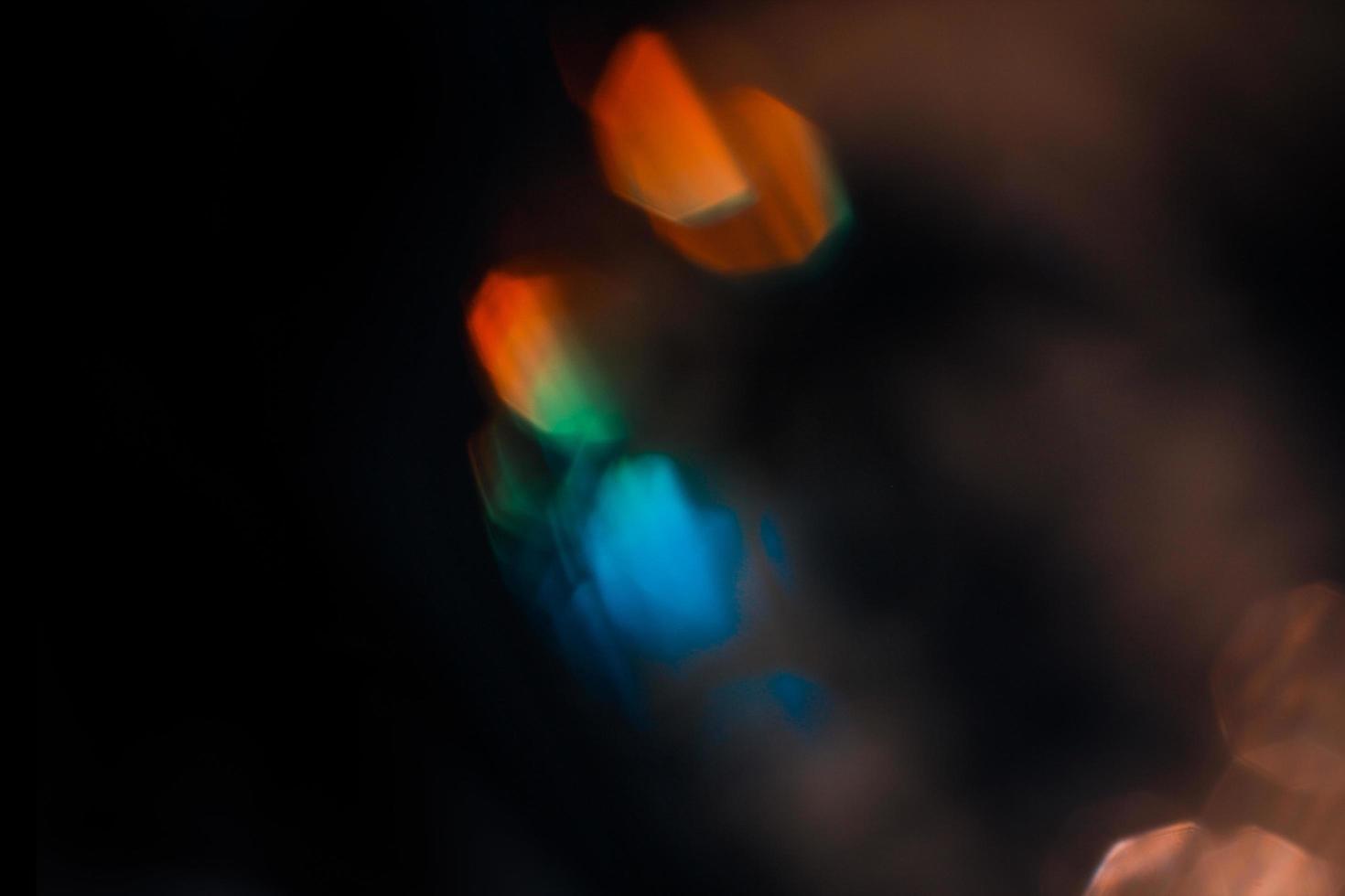 Lens flare and light leak haze texture on a black background. photo