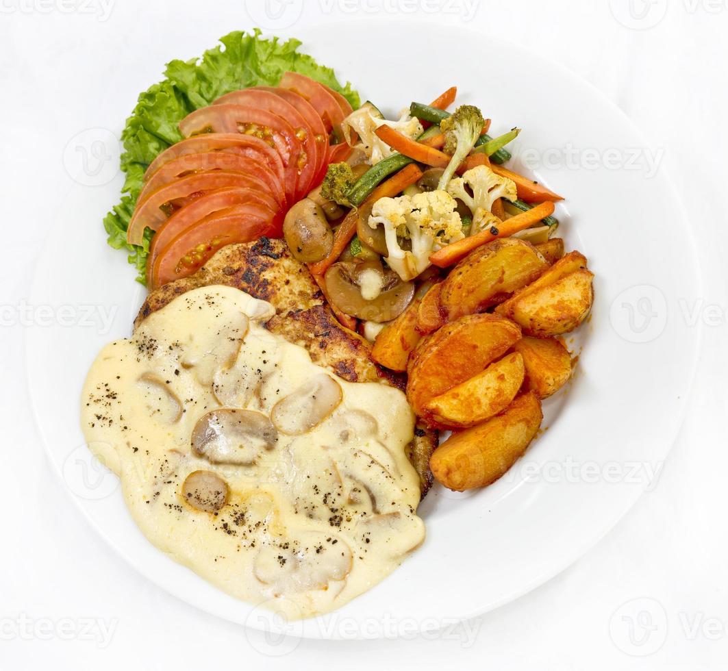 Peri peri Chicken with Button mushroom gravy, Saute Vegetables, Spicy fried Potatoes with Tomato Lettuce Salad. photo