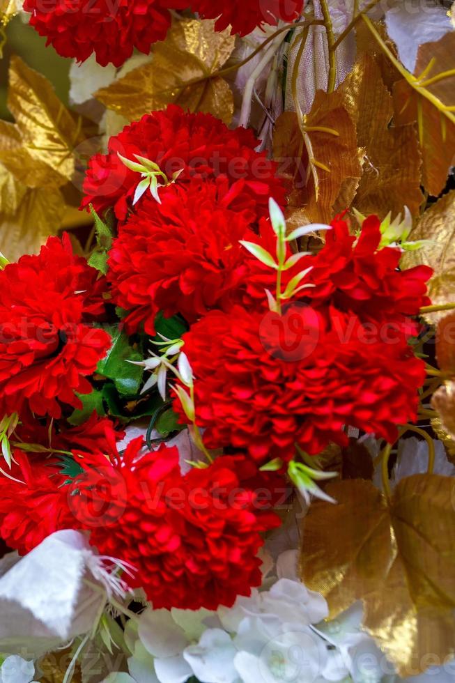 Colorful Red and golden flower and lighting wedding stage decoration. Plastic artificial flower. wedding decoration. photo