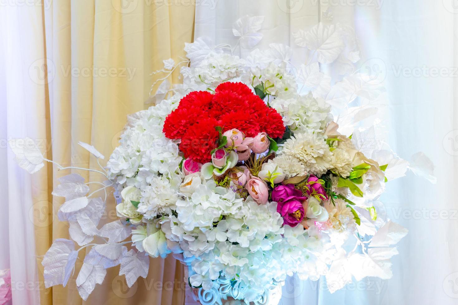 White and yellow artificial paper flowers vase. wedding decoration. Plastic colorful decorated rose flower. photo