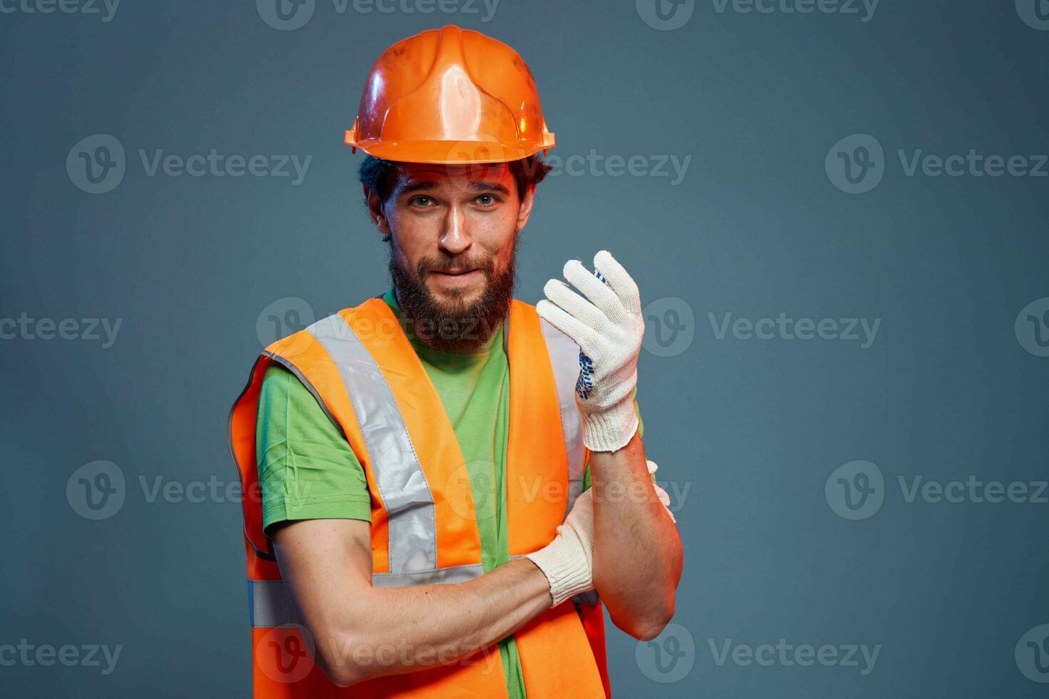 A man in a work uniform is a construction engineer. Industry Professional orange hard hat photo