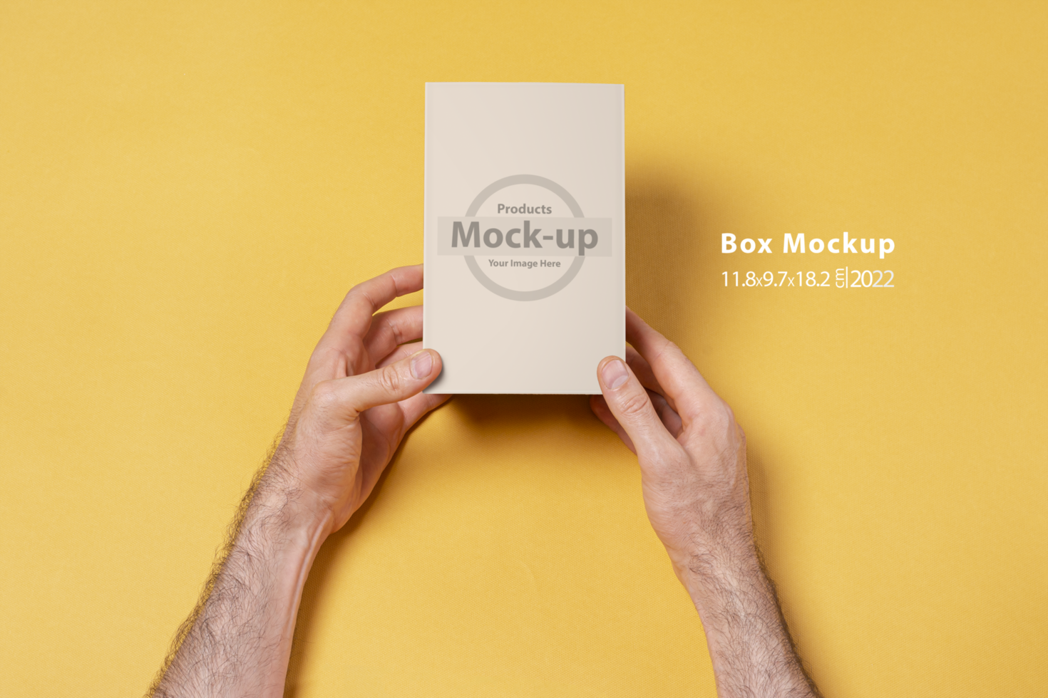 Male hands holding a small box in front of yellow background psd