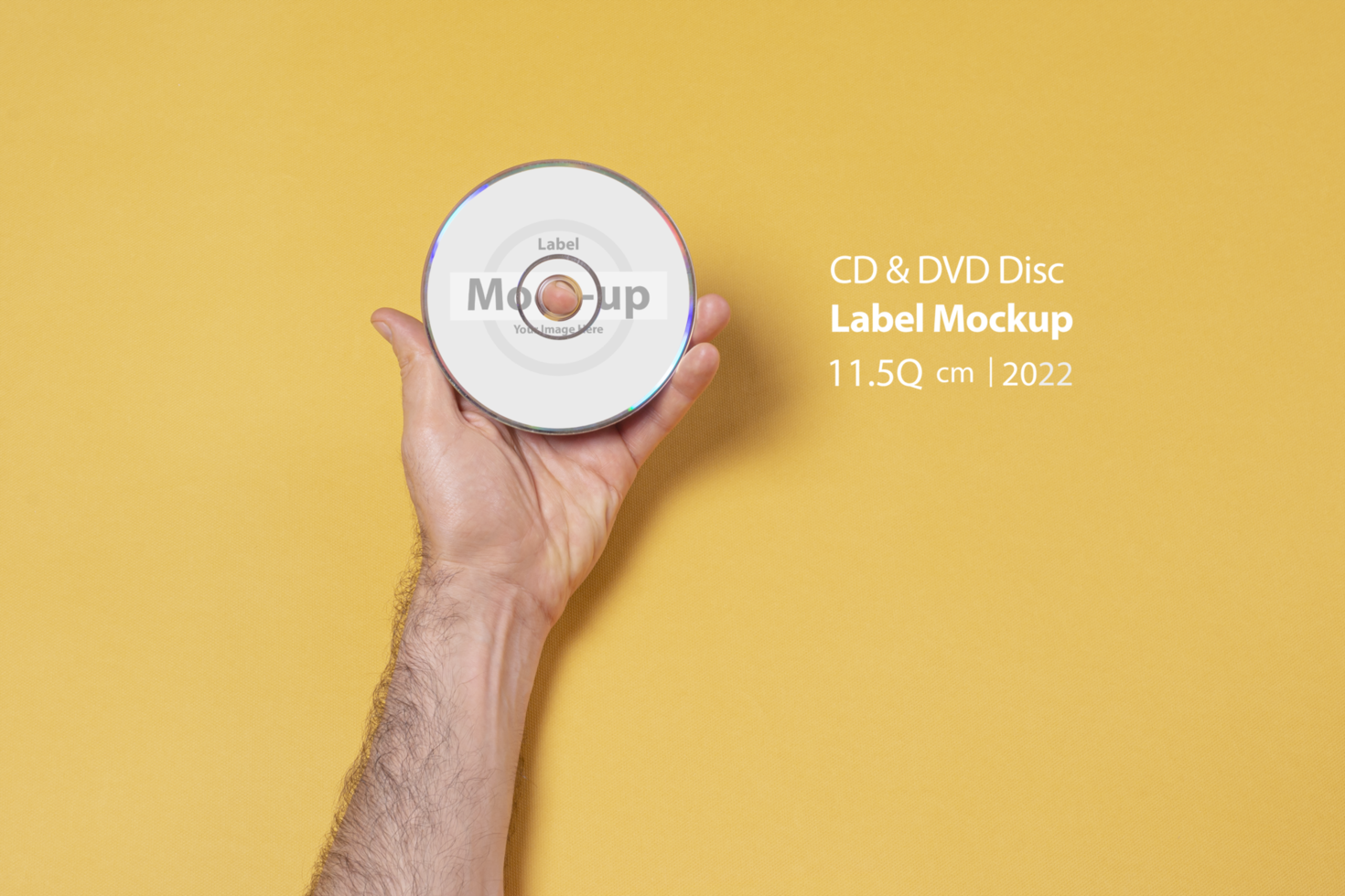 Male hand holding a CD-DVD in front of yellow background psd