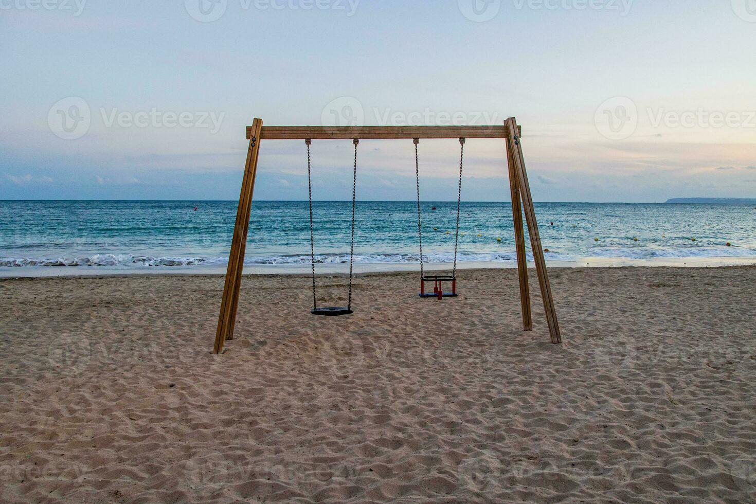 calm beach evening landscape with empty swing photo