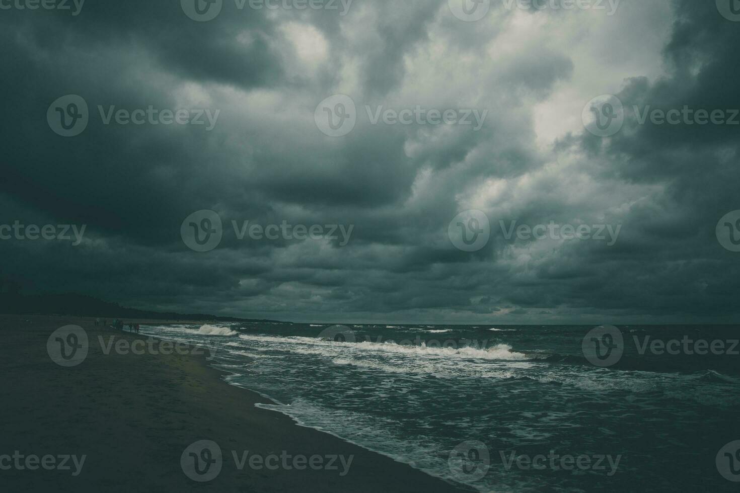 wide beach on the Baltic Sea in Poland on a summer cloudy gray cold day photo