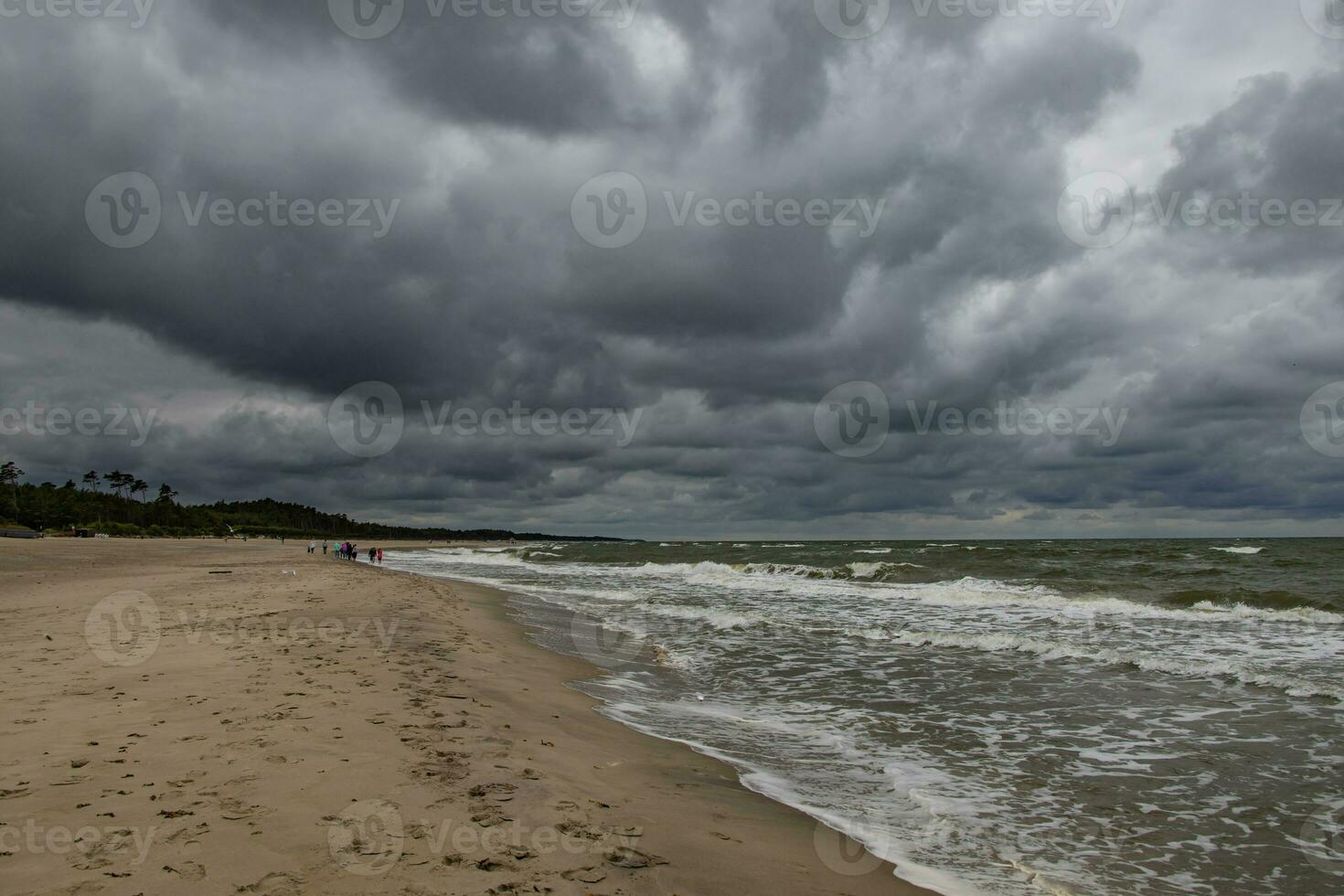 wide beach on the Baltic Sea in Poland on a summer cloudy gray cold day photo