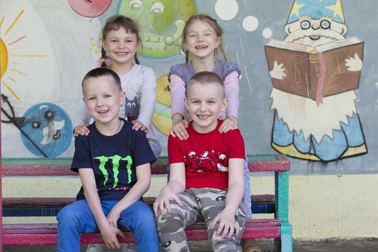 .Cheerful children from kindergarten on a summer walk. photo