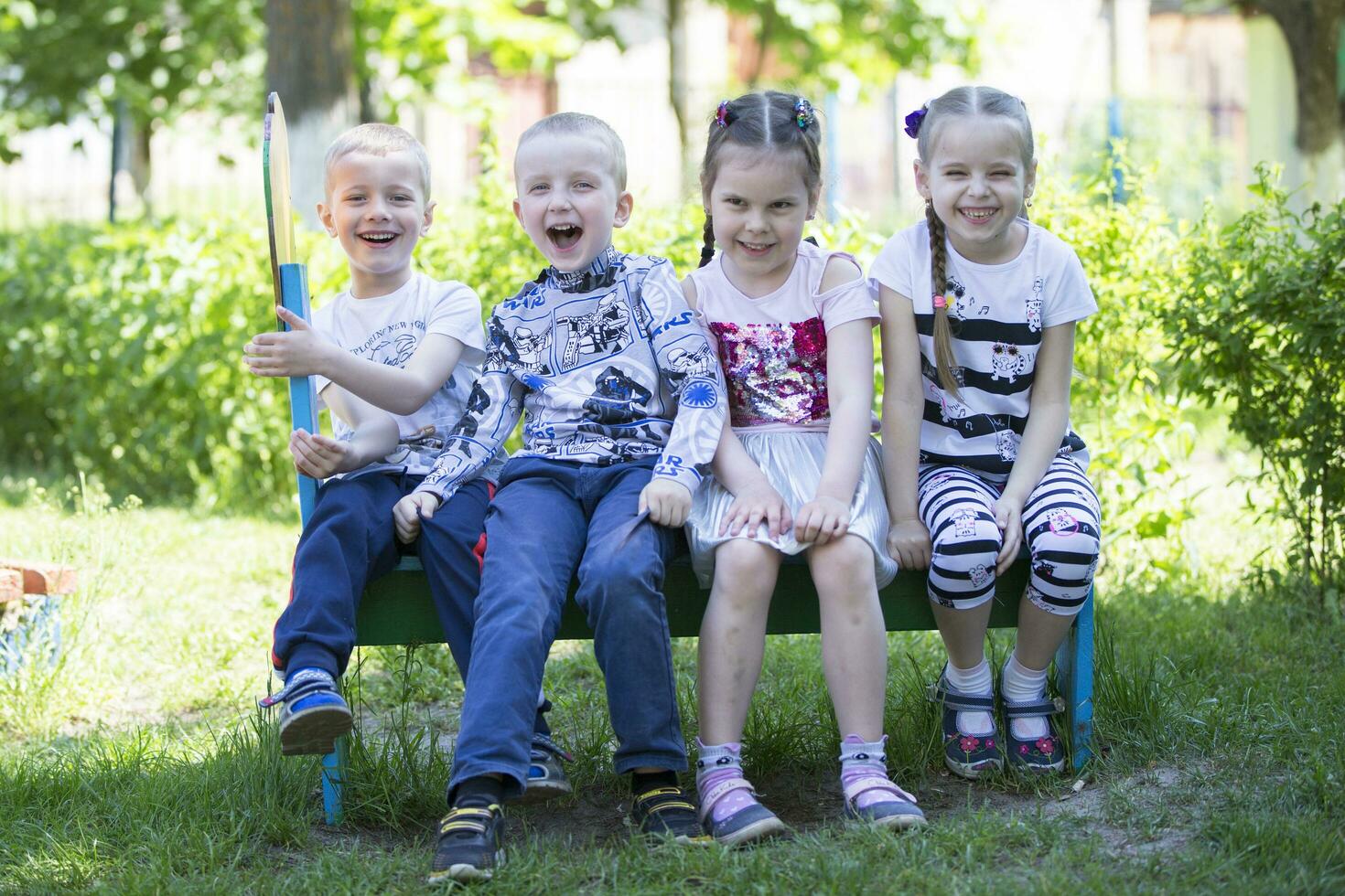 Cheerful children from kindergarten on a summer walk. photo
