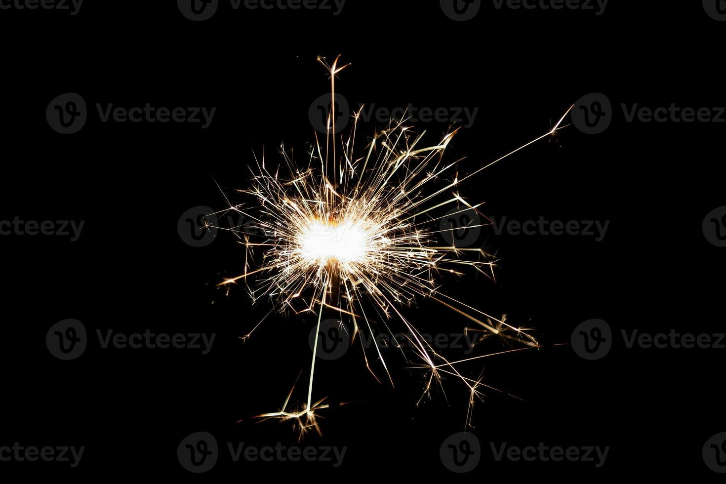 Burning sparkler isolated on black background. Fireworks theme. Light effect and texture. photo