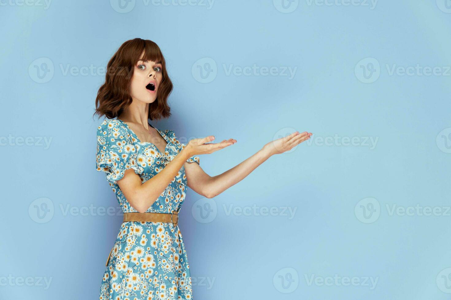 Pretty brunette Surprised look open mouth gestures with hands Copy Space photo