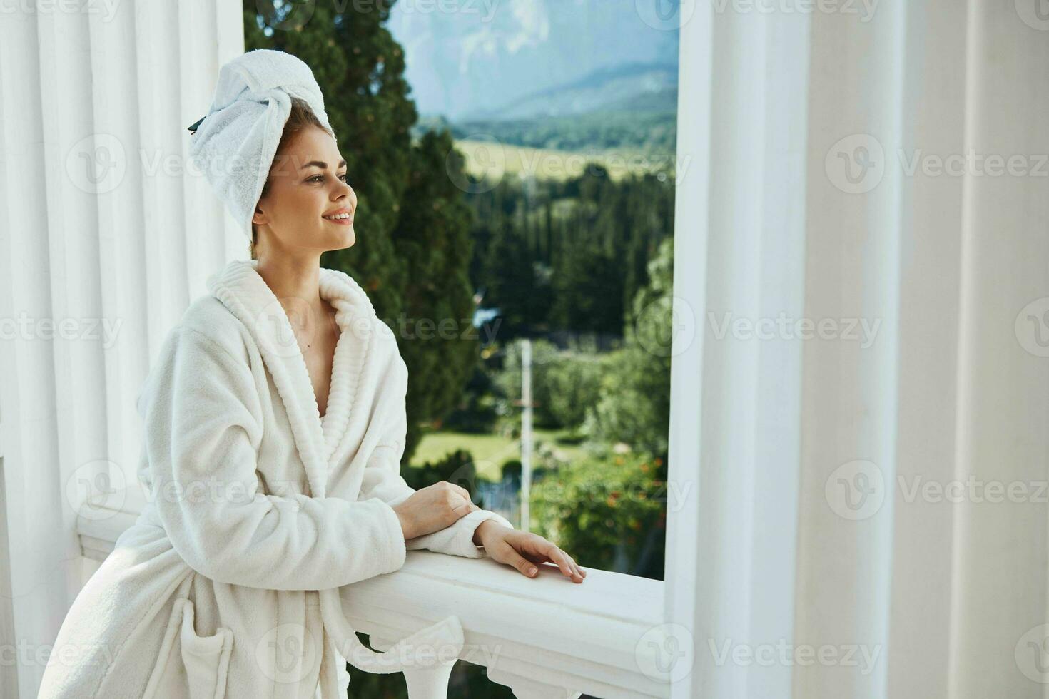 pretty woman posing against the backdrop of mountains on the balcony architecture Lifestyle photo