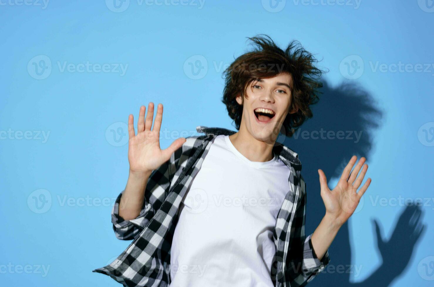 Cheerful guy in plaid shirt tousled hair fashion modern style photo