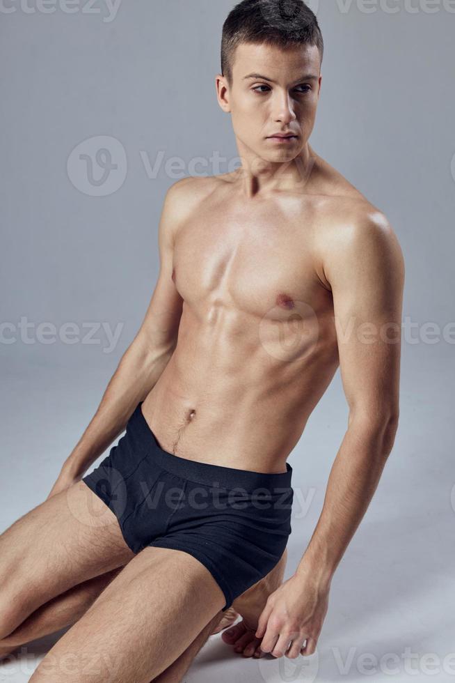 handsome man with pumped up abs black panties posing cropped view model photo