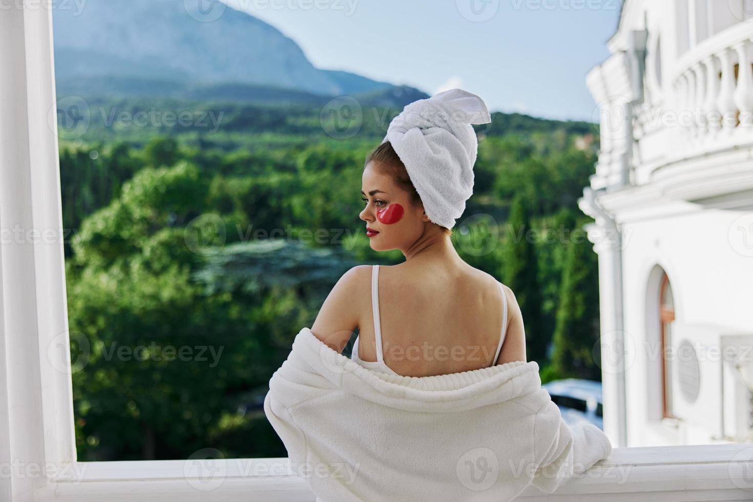 a fit girl stands on the balcony of the hotel Perfect sunny morning photo
