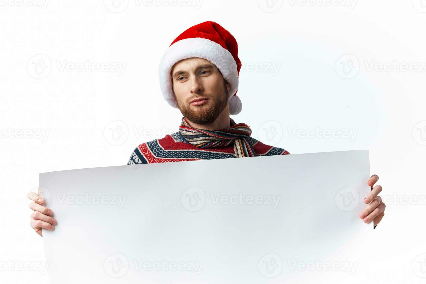 Cheerful man in a christmas hat with white mockup poster christmas isolated background photo