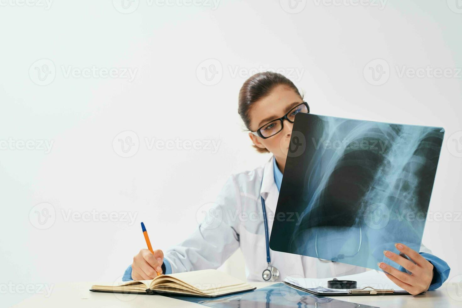 female doctor look at x-ray diagnostics treatment hospital photo