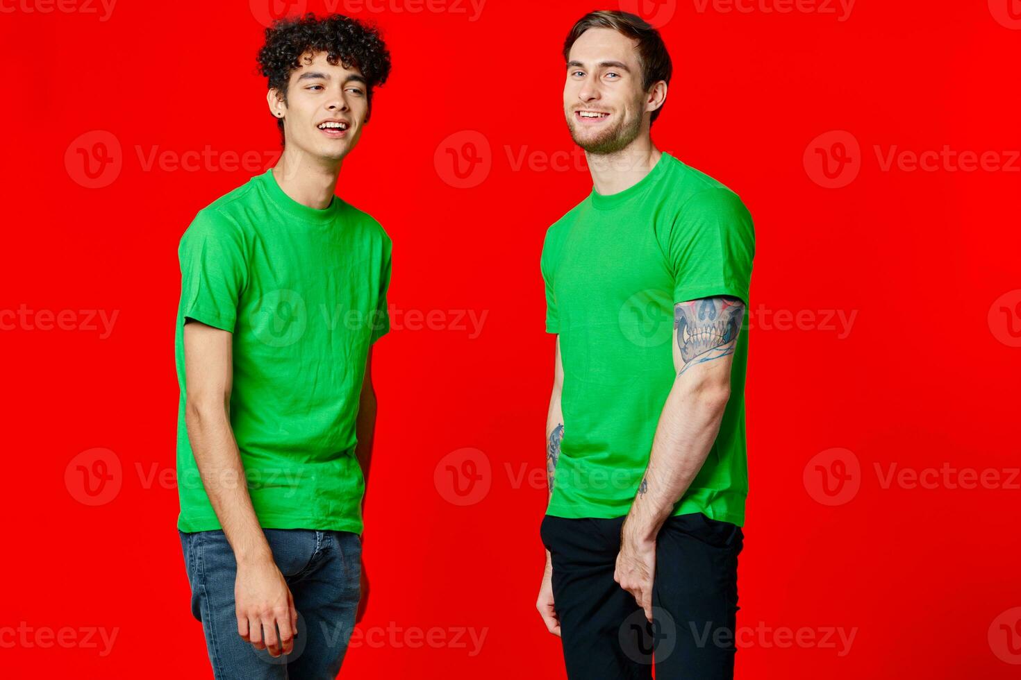 two friends in green t-shirts fun communication red background photo