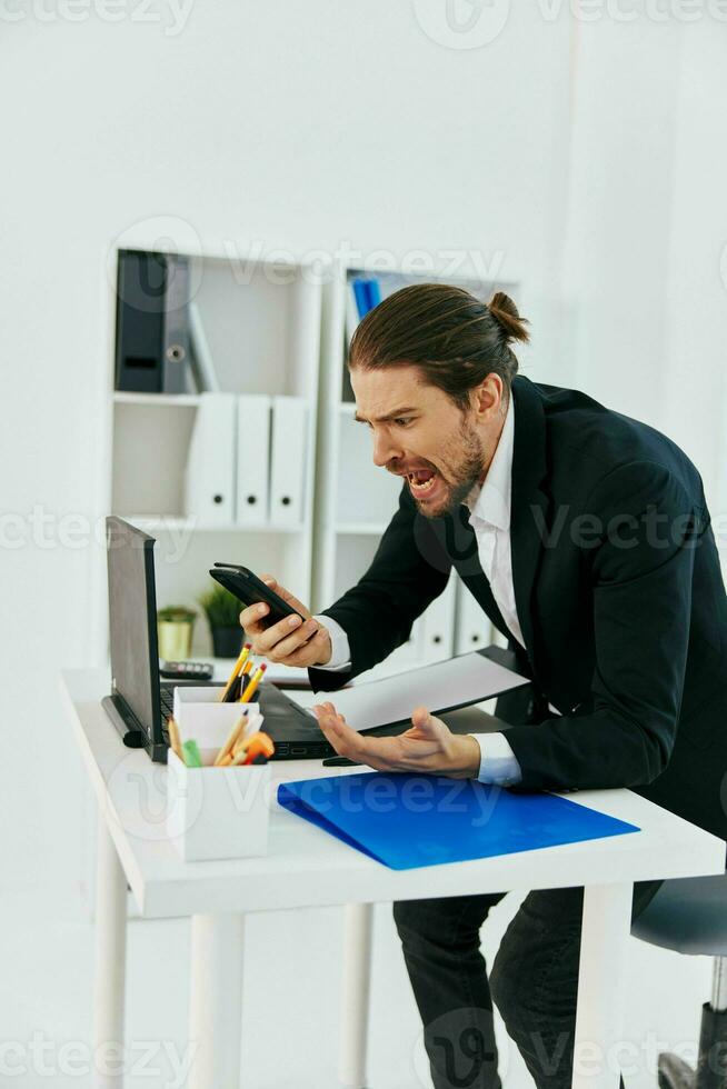 office worker at the desk documents communication by phone technology photo