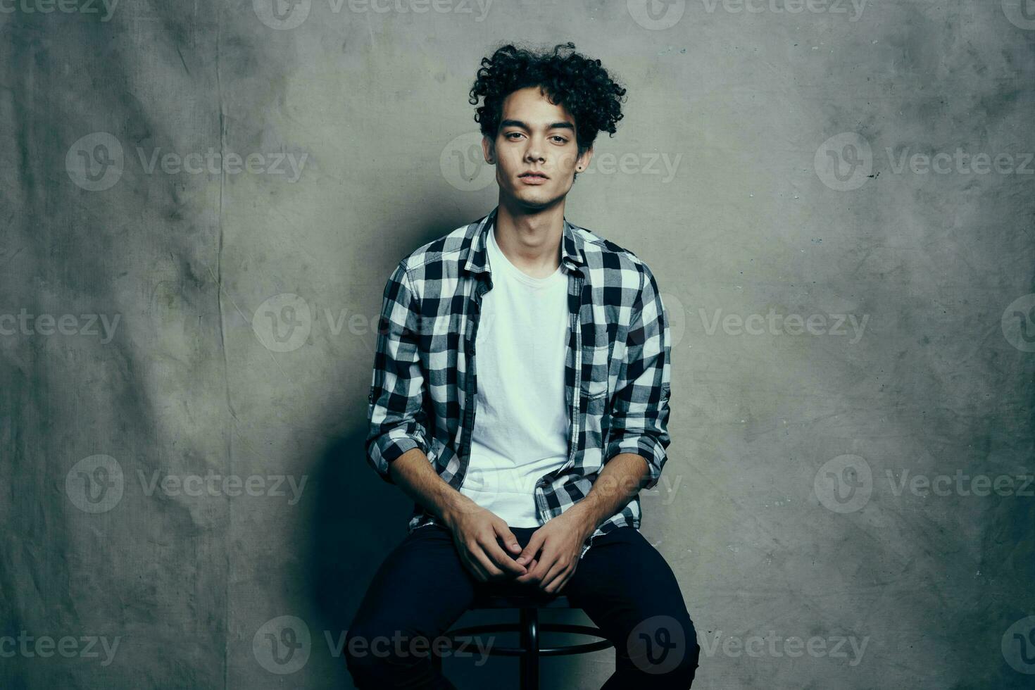 handsome man curly hair plaid shirt fashion studio emotion photo