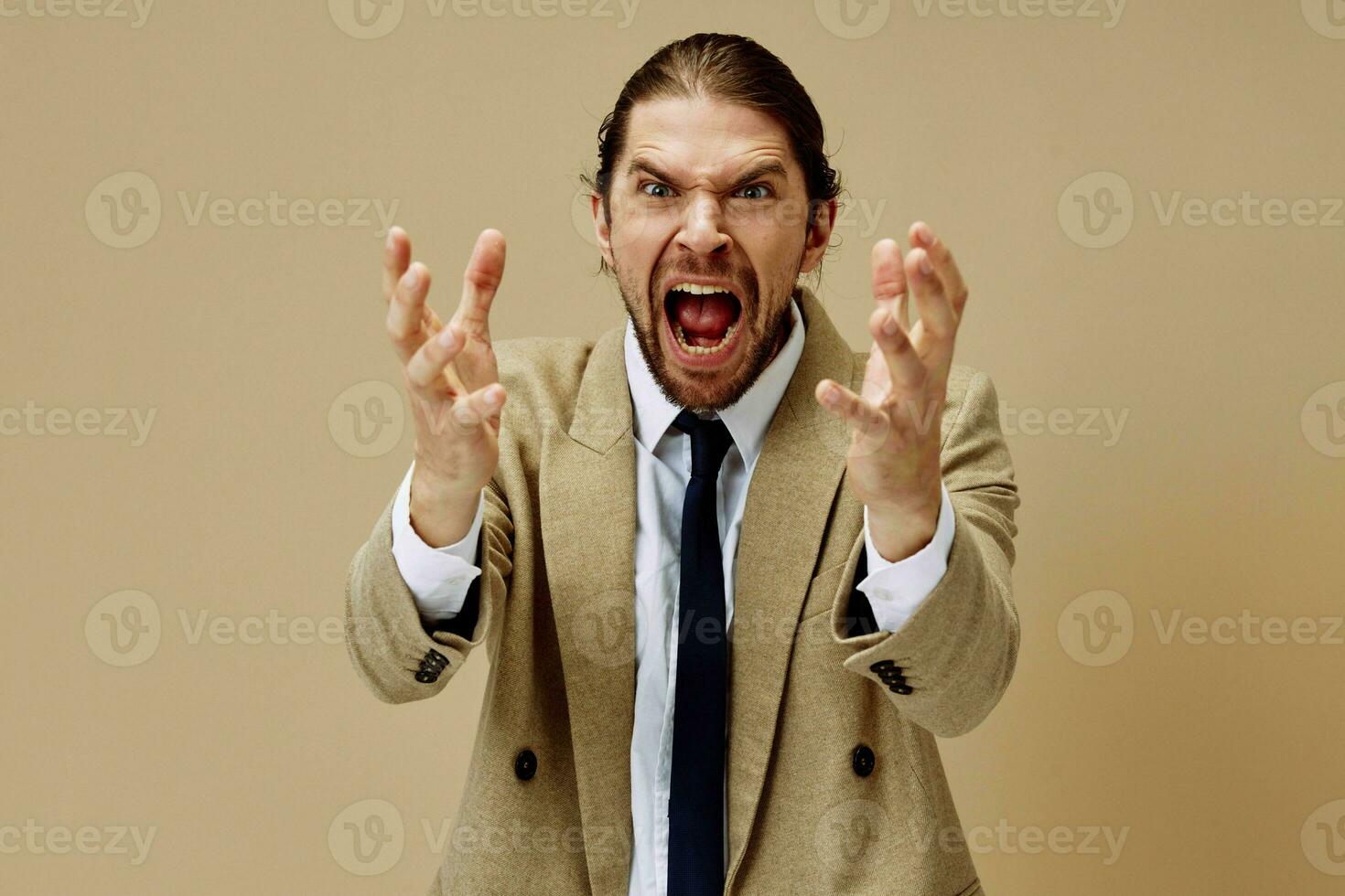 fashionable man emotional man in suit gesture with hands beige background photo