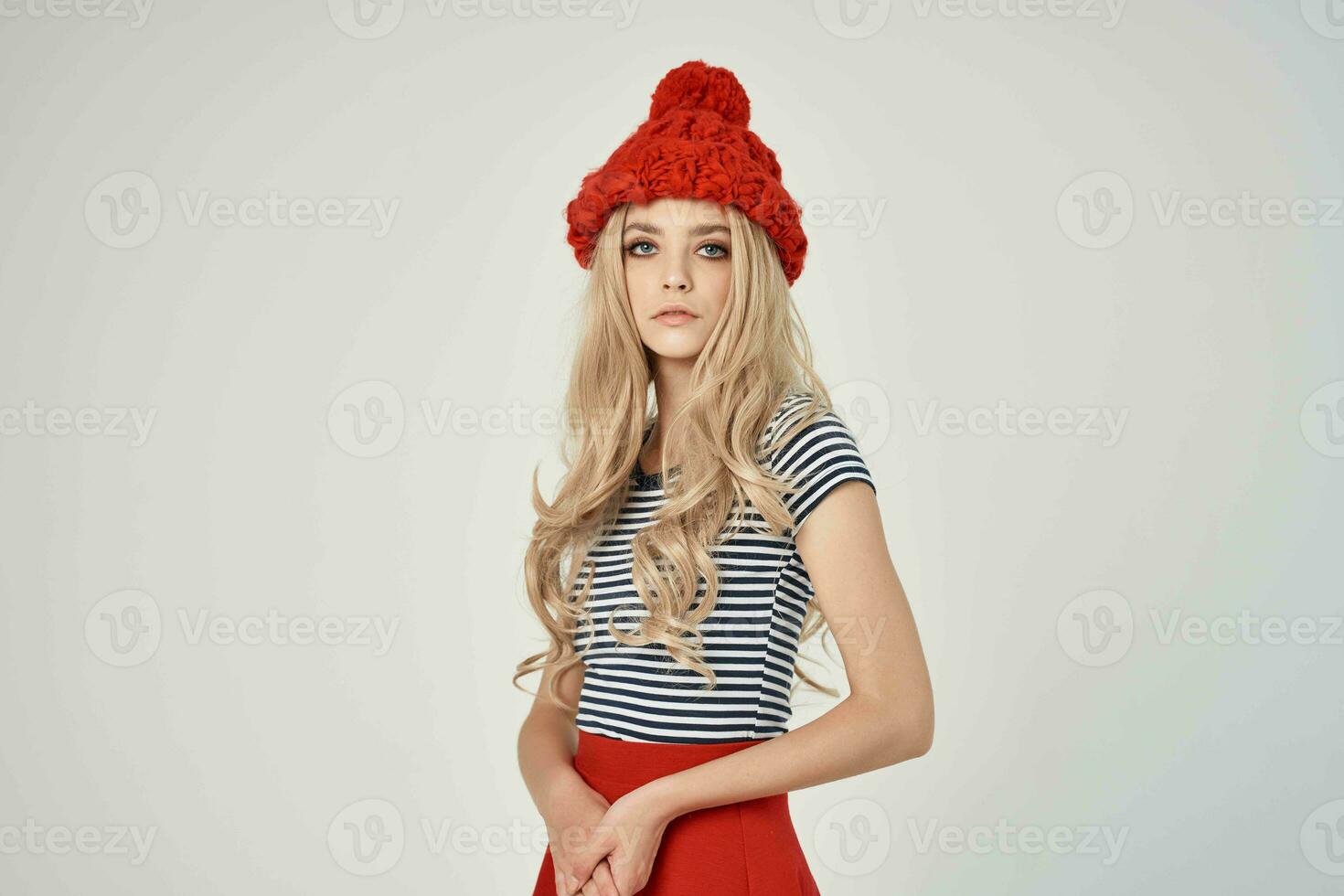 pretty woman in fashionable clothes Red Hat light background photo