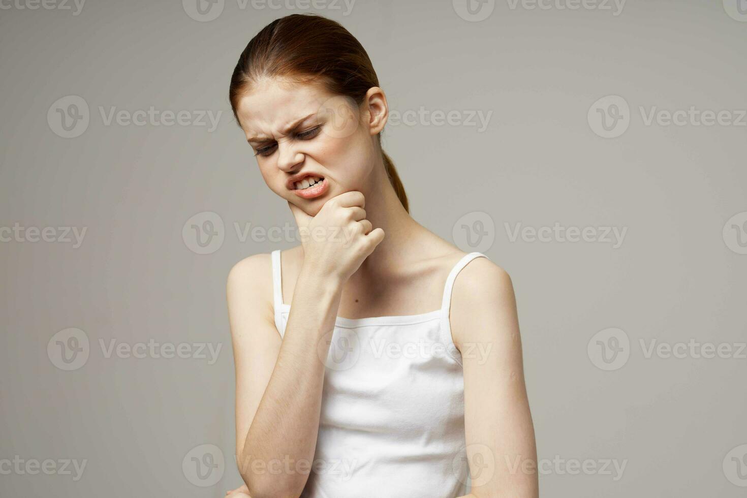 disgruntled woman dentistry dental pain close-up light background photo