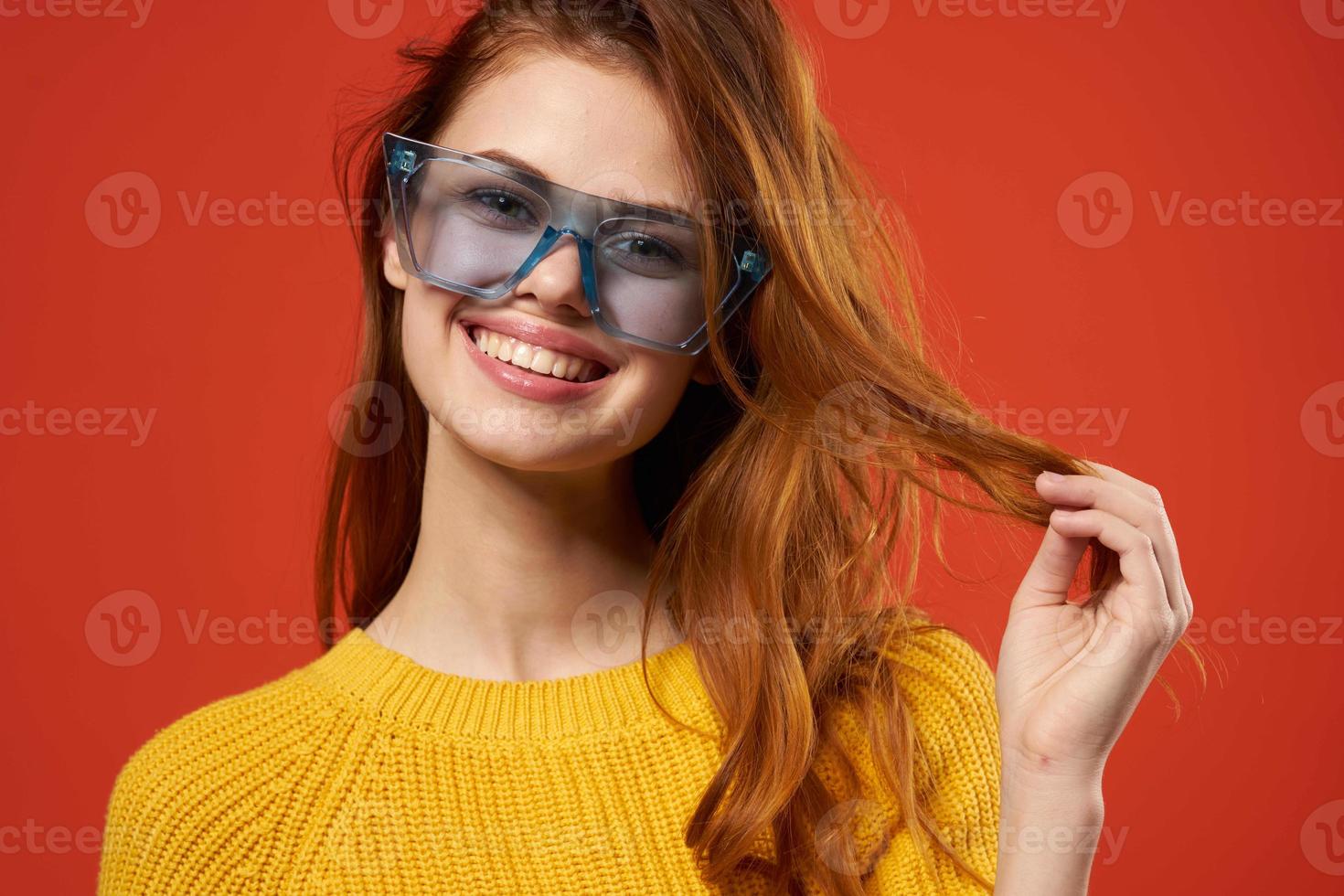 cheerful attractive woman holding hair glasses fashion studio photo