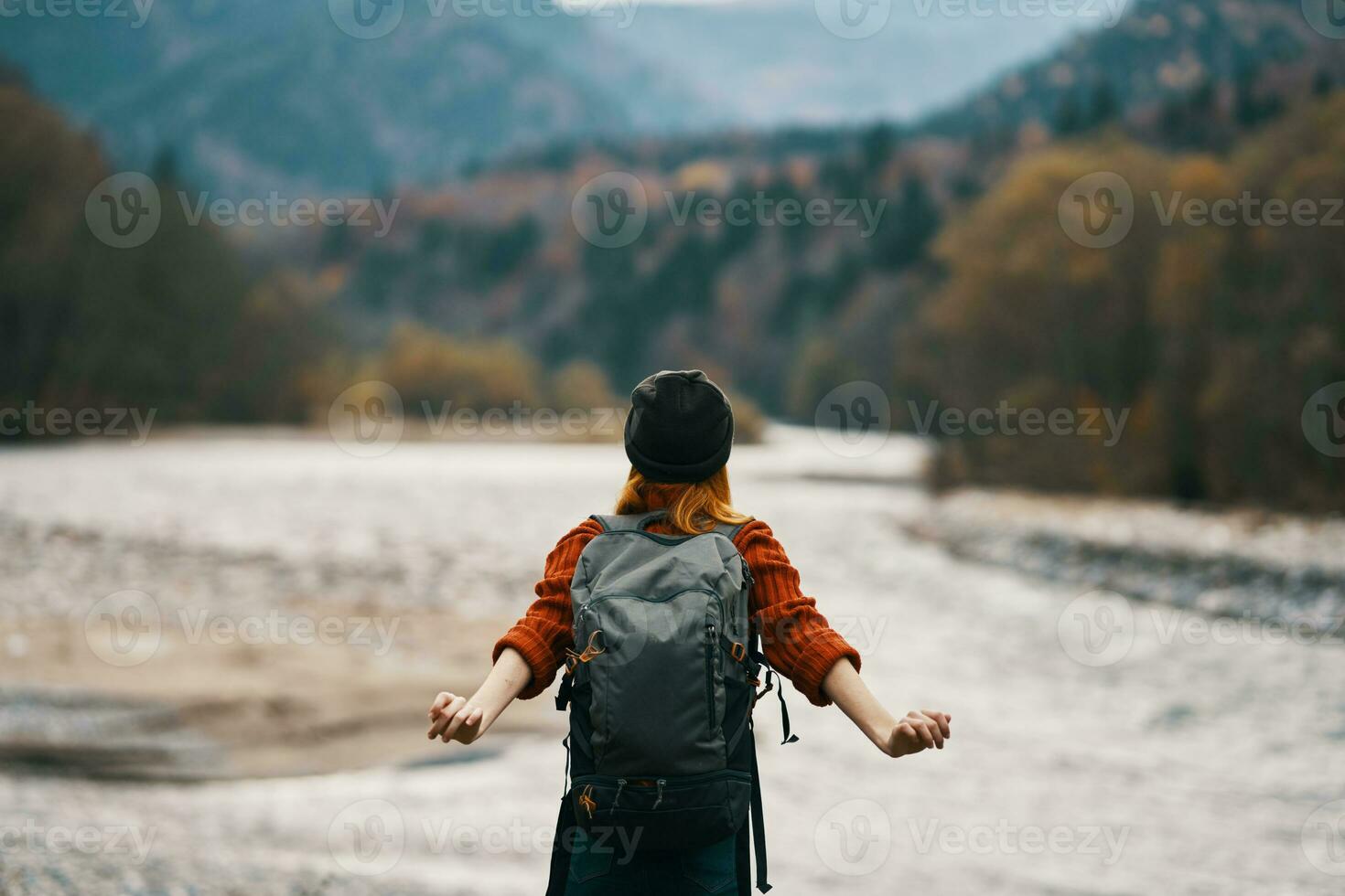 young woman on the river bank with backpack tourism model travel mountains photo