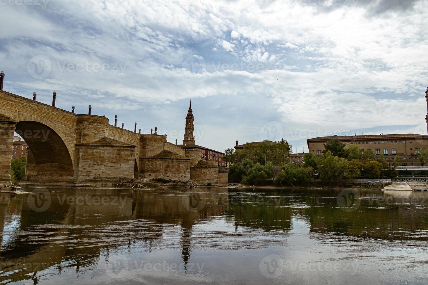 stone historic bridge over the Ebro river in Zaragoza spain photo