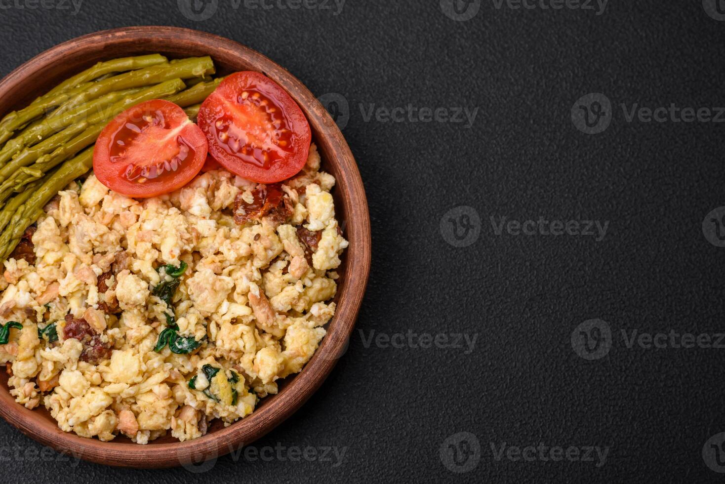 Delicious scramble with salmon, sun-dried tomatoes, spinach, spices and herbs photo