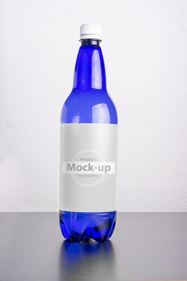 Blue bottle with label on table surface psd
