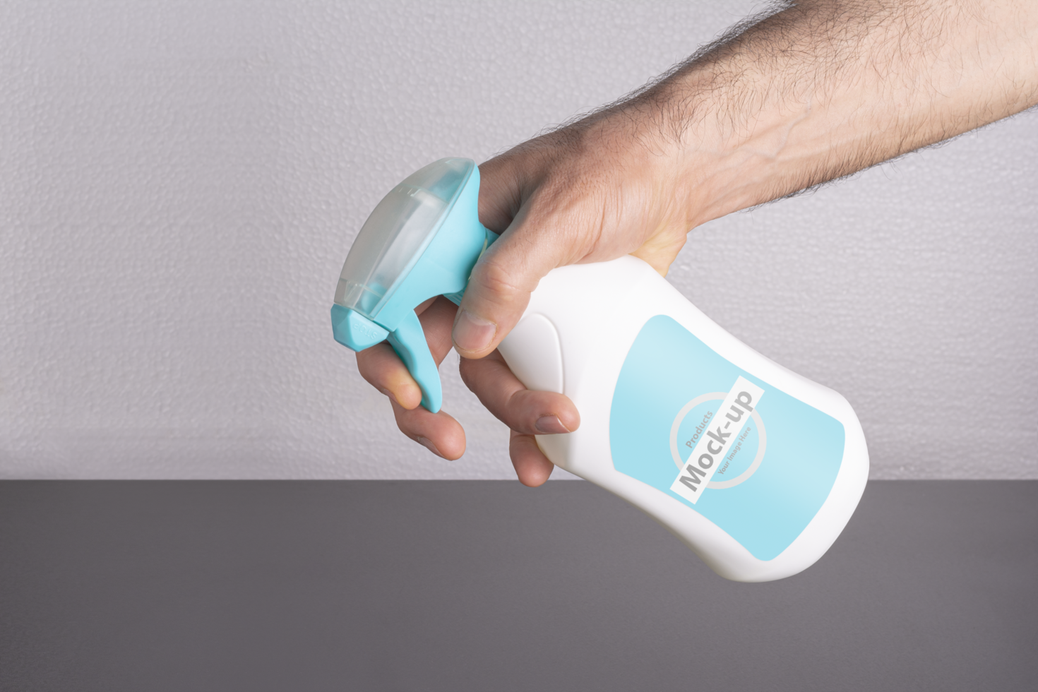 A man hand holding a cleaning liquid bottle in front of  white background psd