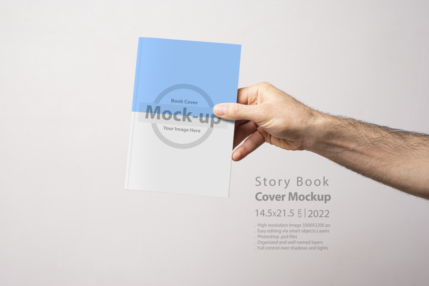 Male hand holding a closed book-catalog with blank cover psd
