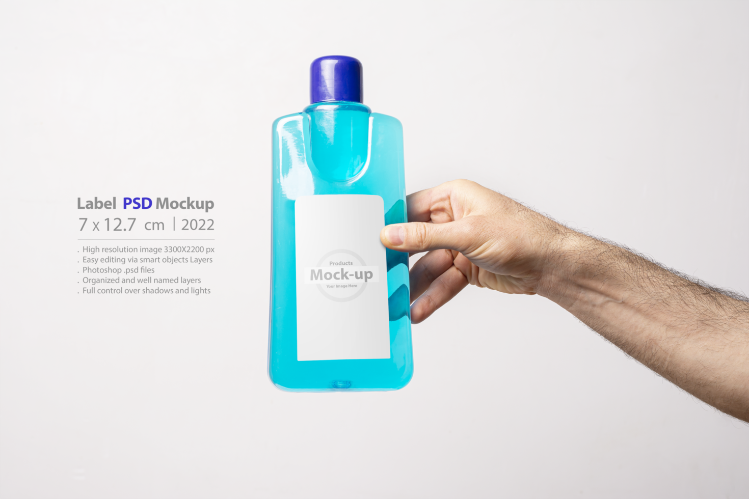 Hand holding a carpet cleaning liquid bottle in front of light gray background psd