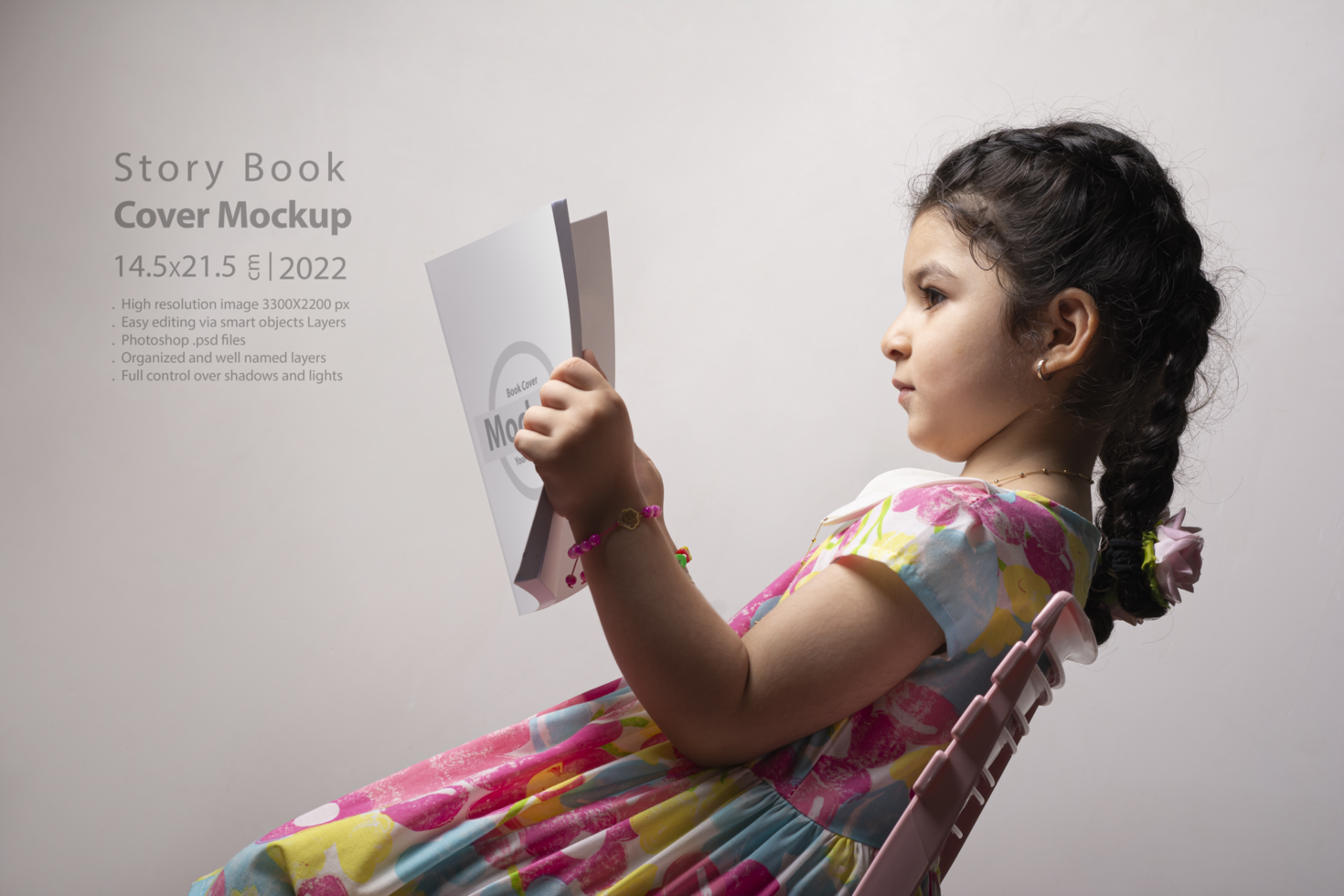 Little girl reading a book with blank cover in front of body psd