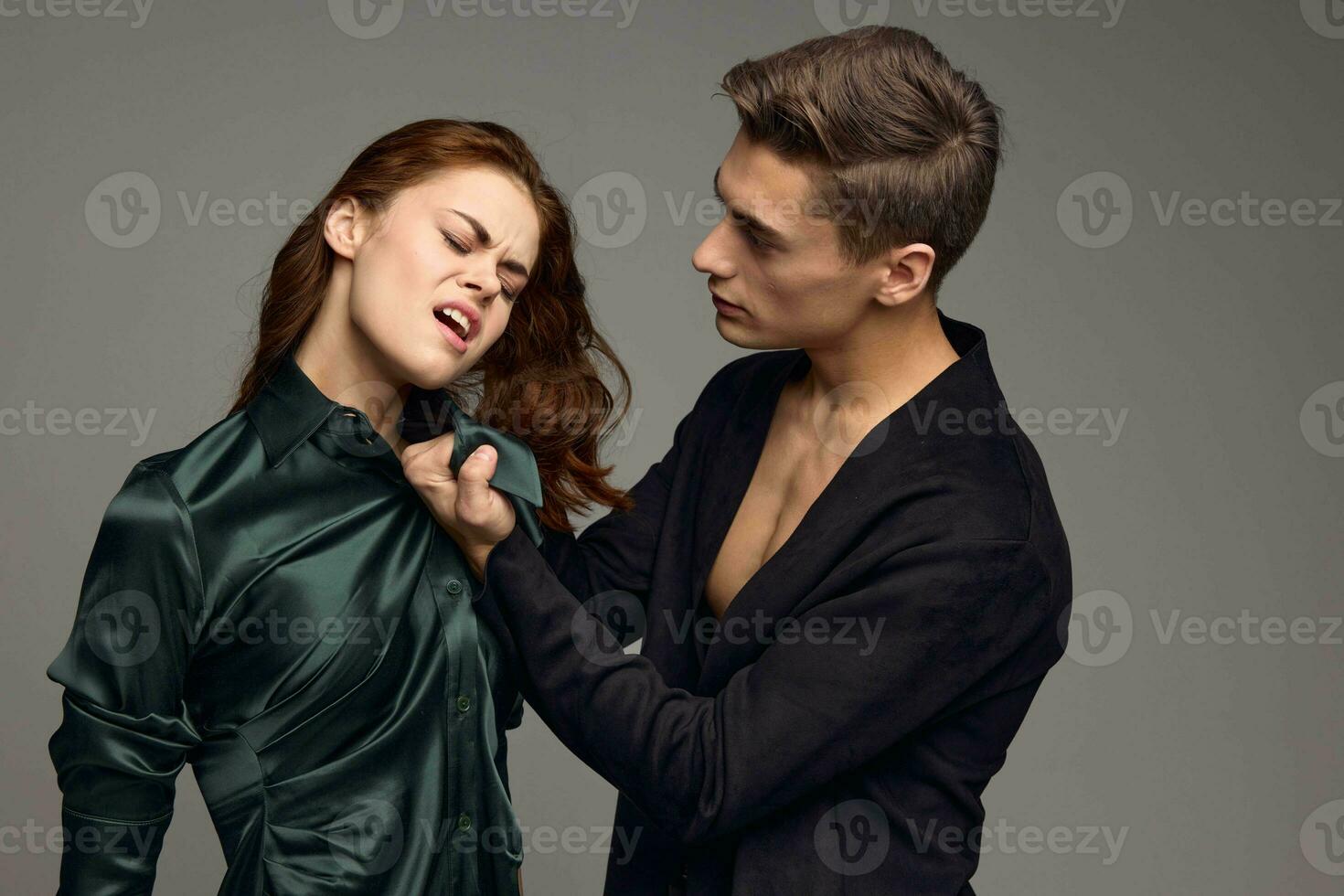 A man in a jacket hurts a woman in a dress domestic violence photo