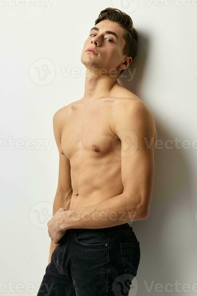 Cute man words pumped up muscular torso posing glamor and luxury photo