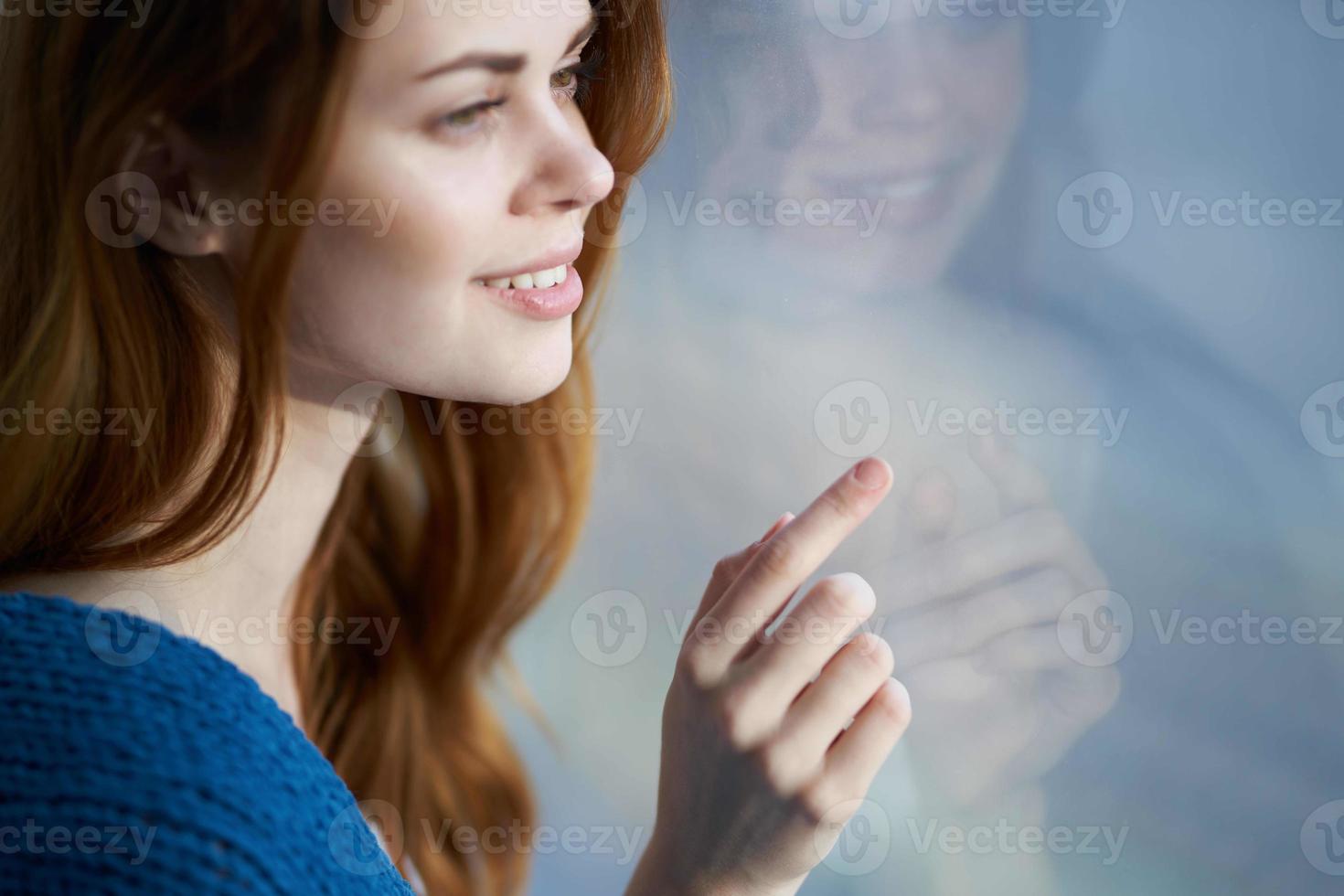 woman sitting near the window with a blue plaid morning photo