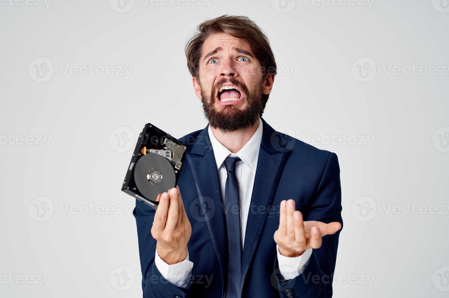 emotional business man with hard drive on computer technology photo