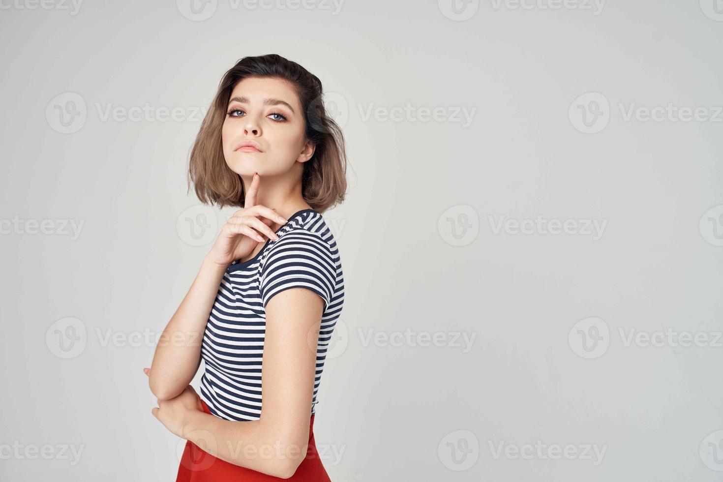 pretty woman with glasses Red skirt light background photo