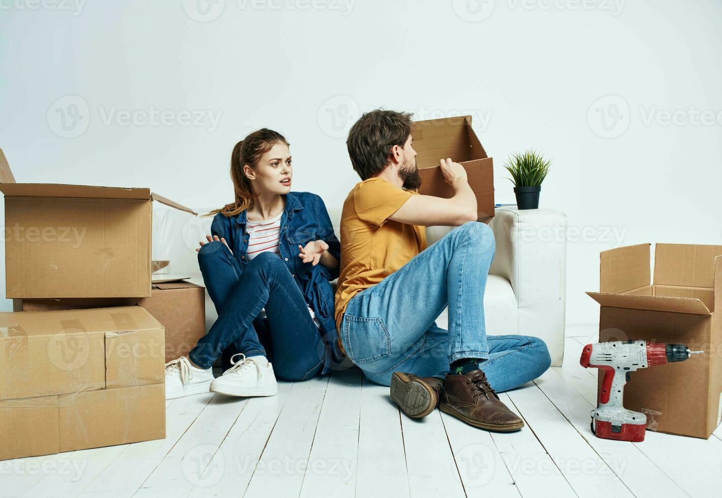 man and woman moving apartment flower potted and boxes repair tools photo