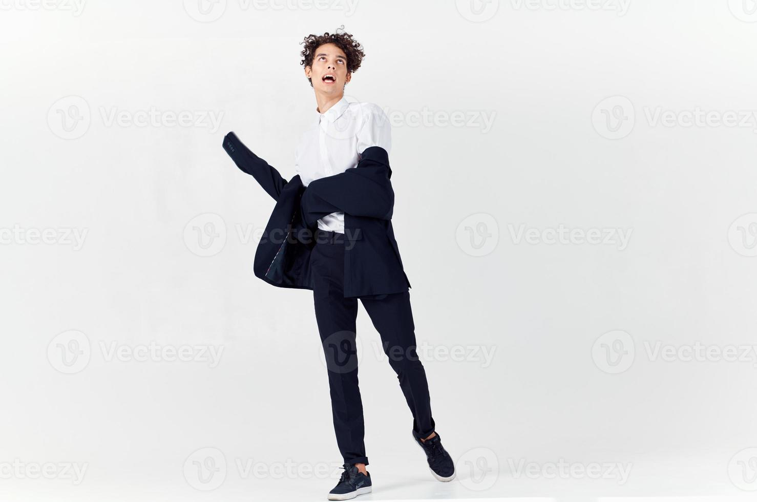 business man in suit and curly hair emotions light background fashion photo