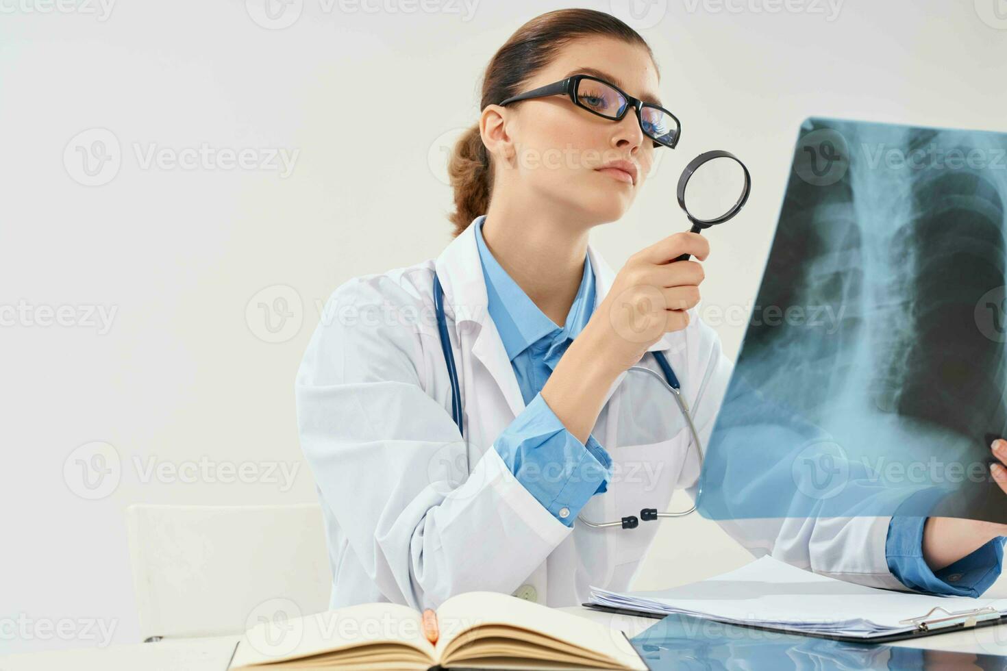female doctor look at x-ray diagnostics treatment hospital photo