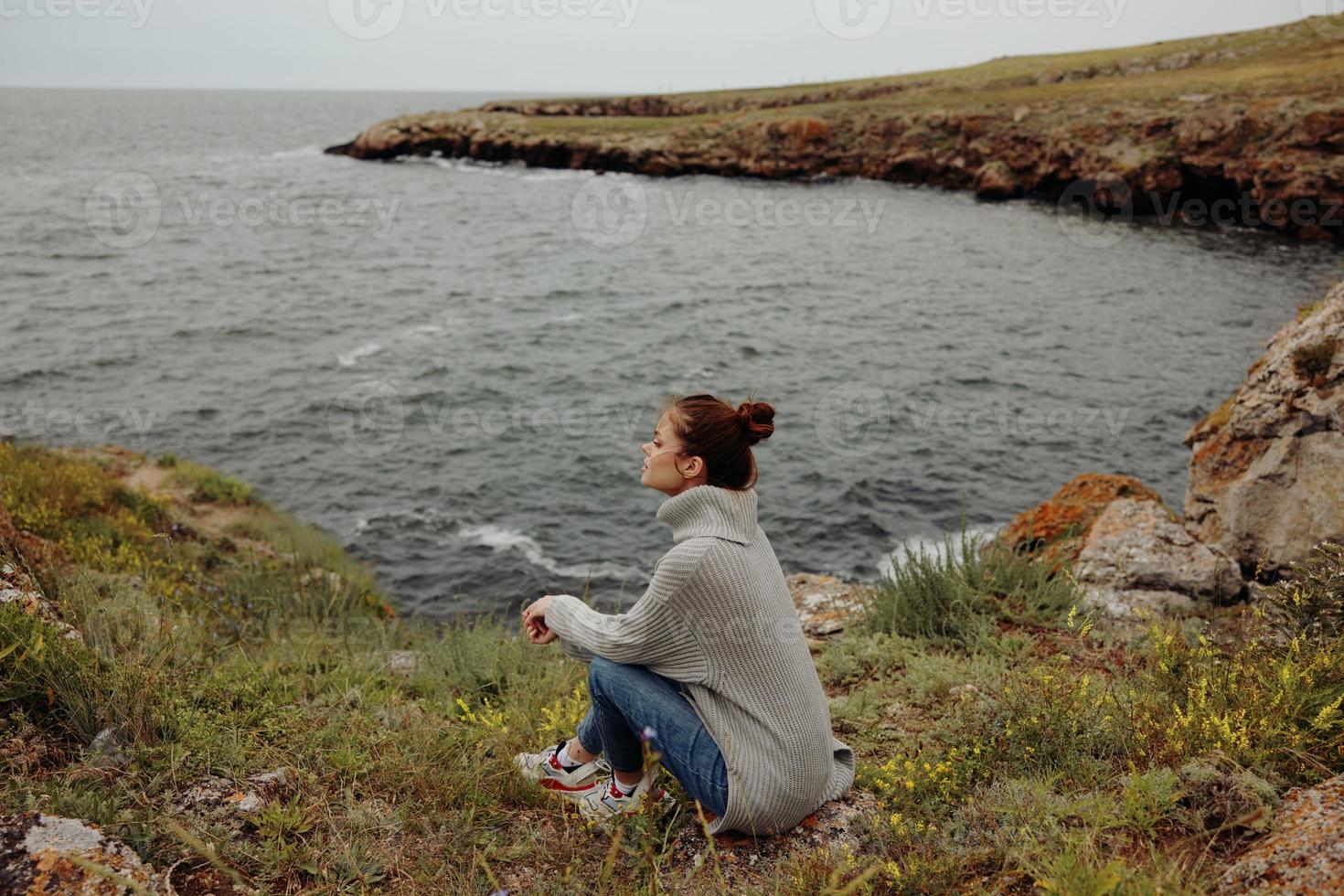 woman beach tourism cloudy weather stone coast Relaxation concept photo