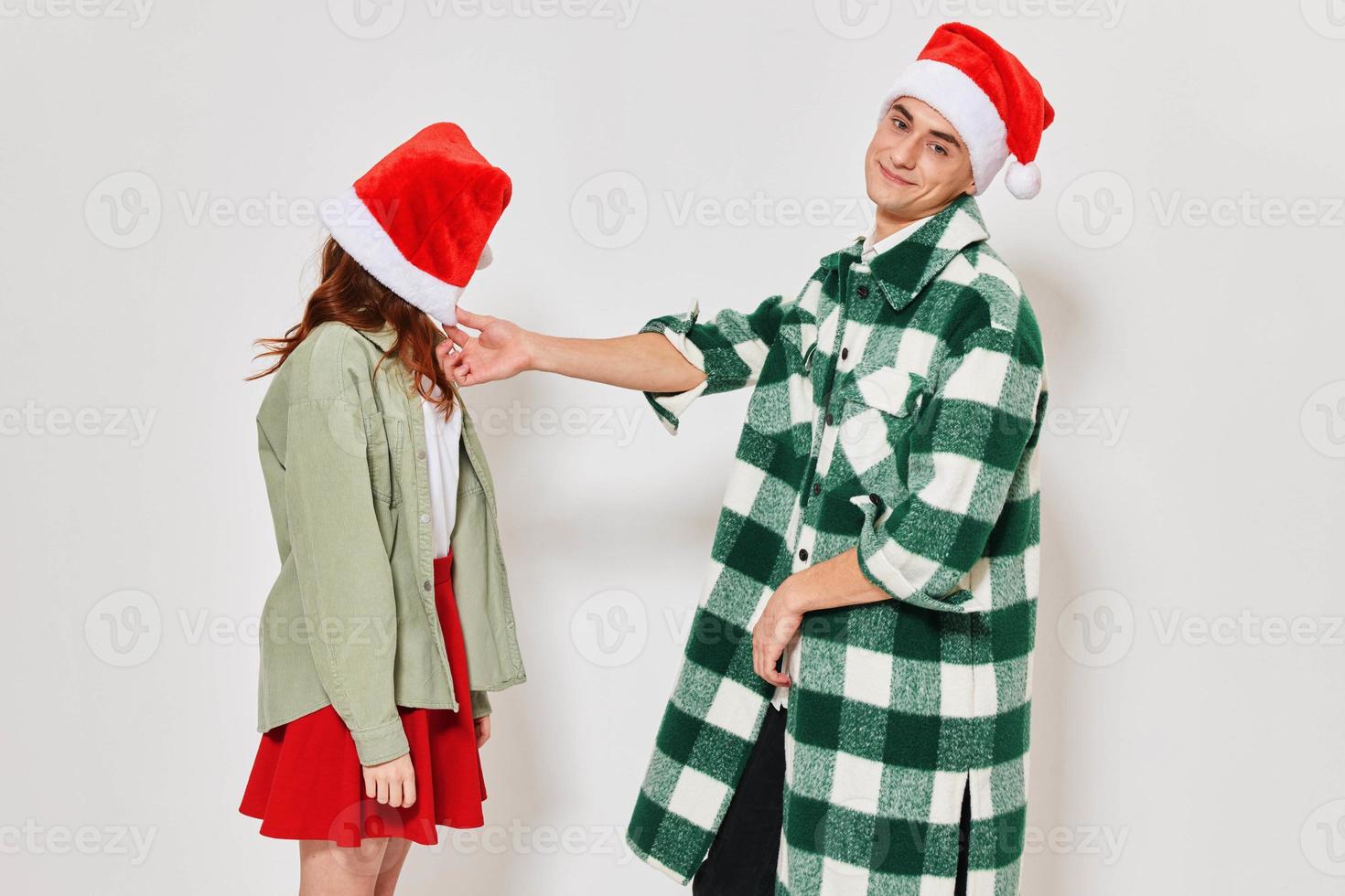 A man stands next to a woman Christmas hat emotions holiday relationship photo