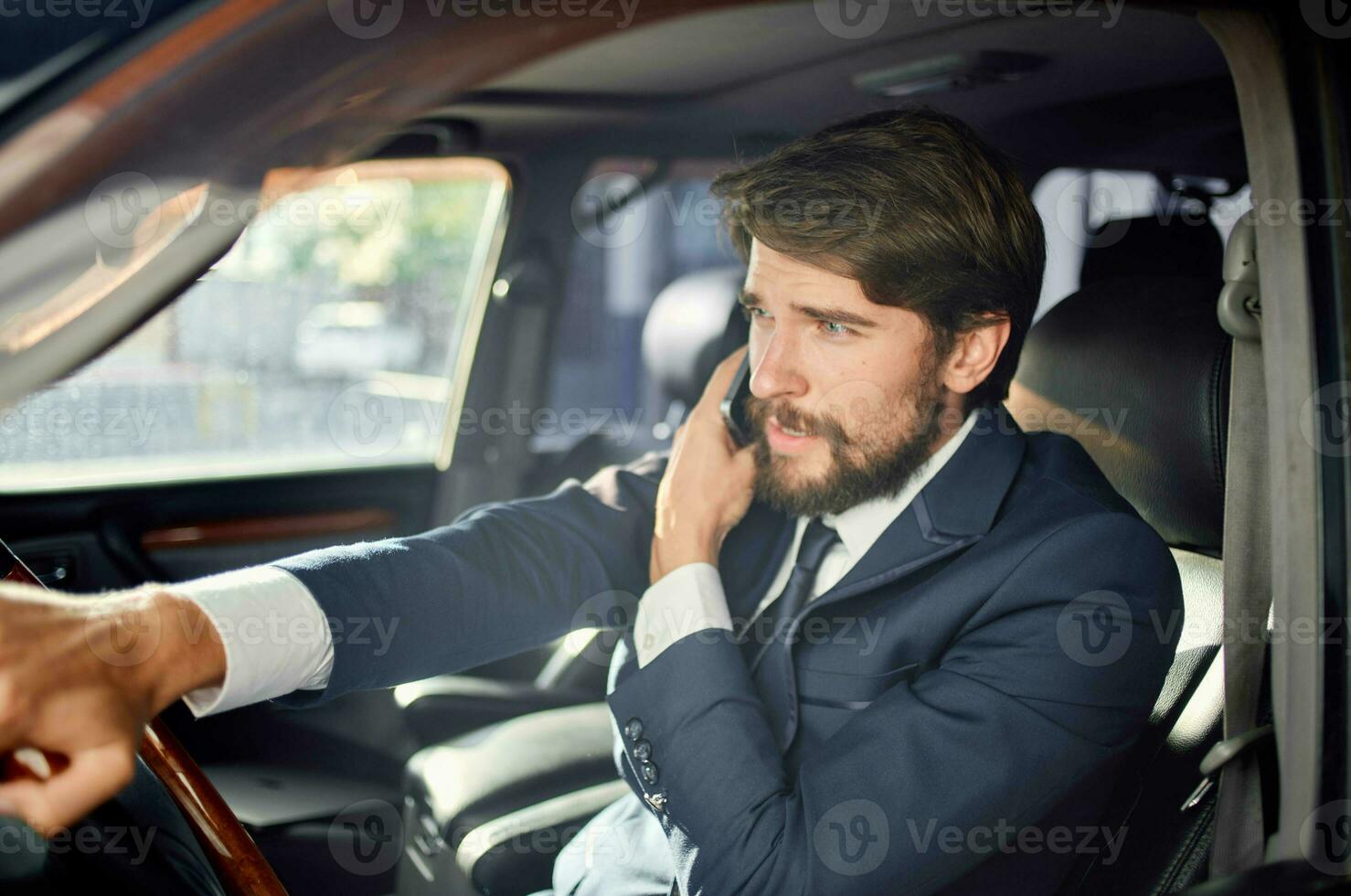 bearded man Driving a car trip luxury lifestyle success service rich photo