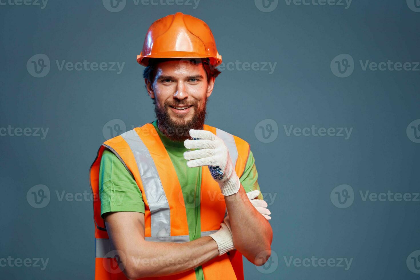 A man in a work uniform is a construction engineer. Industry Professional orange hard hat photo