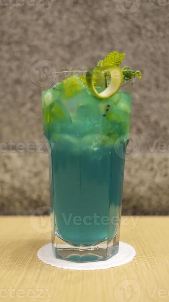 Blue lychee mocktail beverage, consist of orange juice, lychee and blue curacao mixed with soda. photo