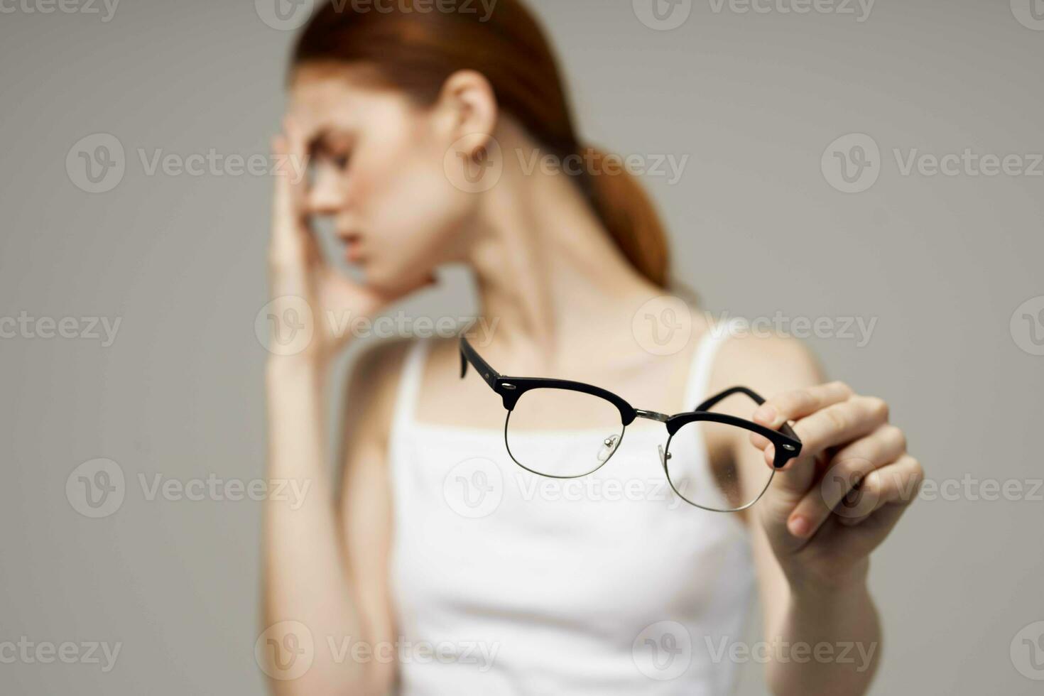 disgruntled woman poor eyesight health problems negative light background photo